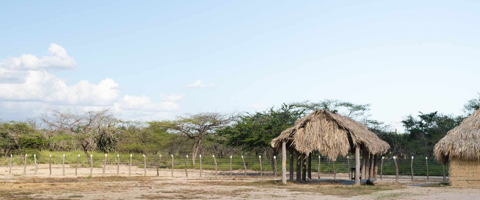 Landscape with buildings in typical Wayuu ranch in Guajira. Colombia. Copy space.
